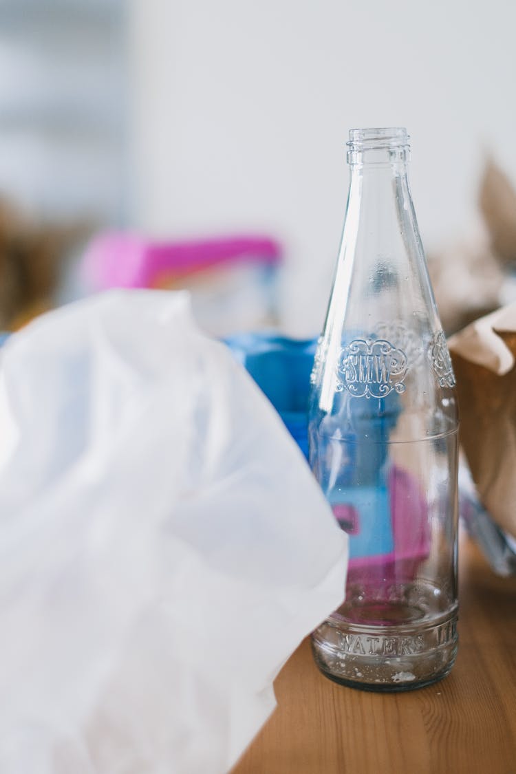 Glass Bottle Near Plastic Bag And Paper For Utilization