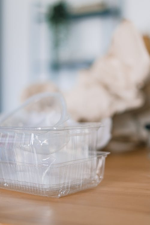 Stack of plastic containers near crumpled paper