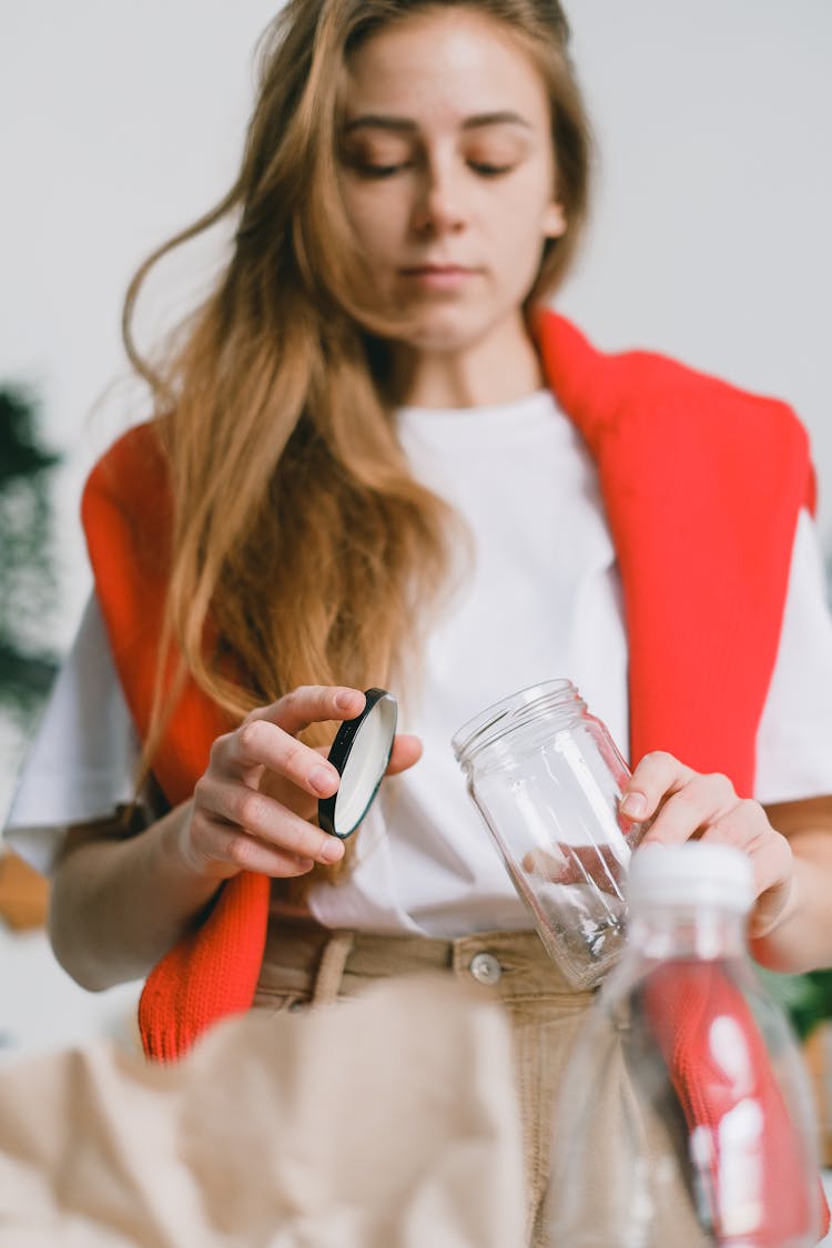 Woman Separating Lid From Glass Jar