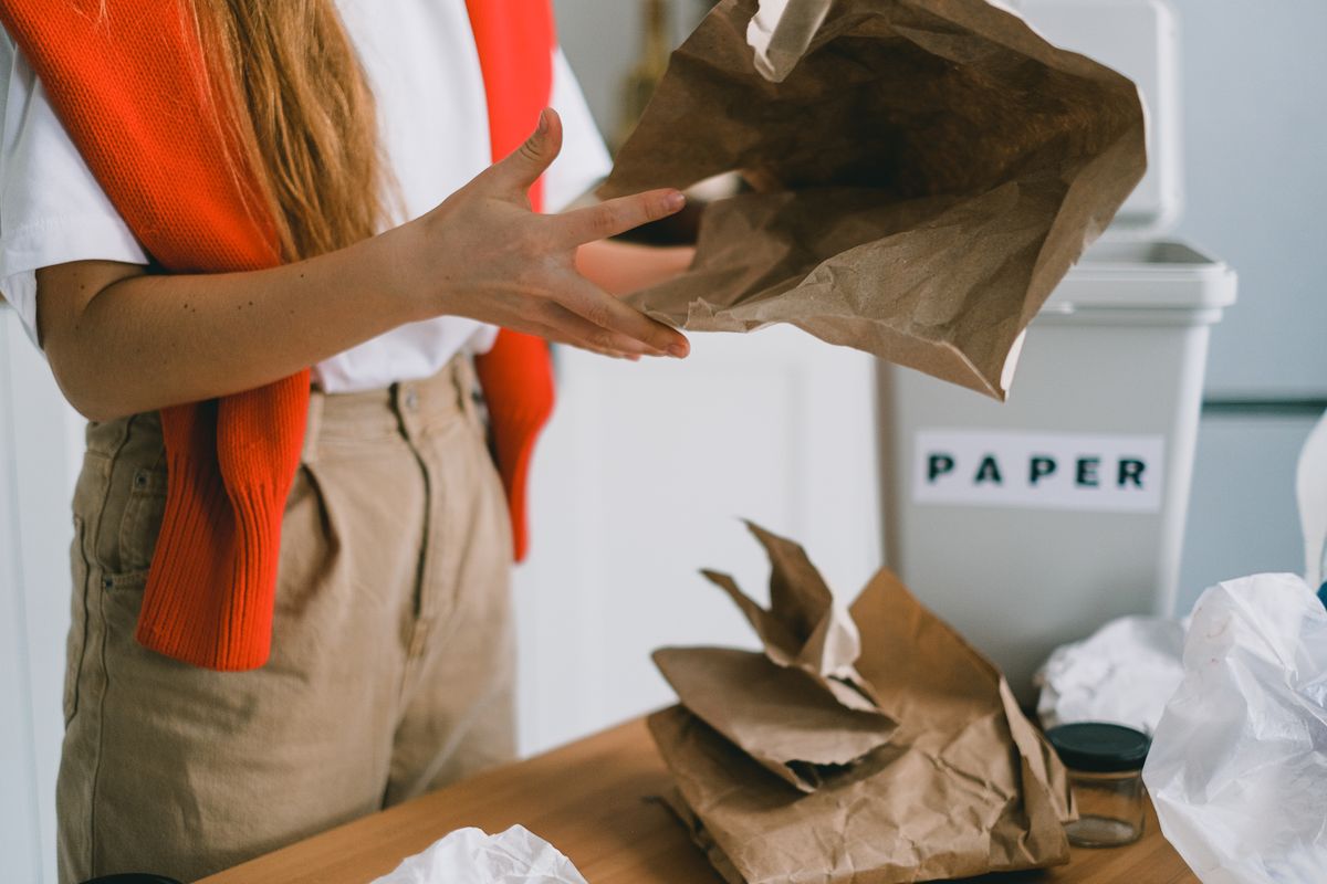 Person sorting paper and household recycling