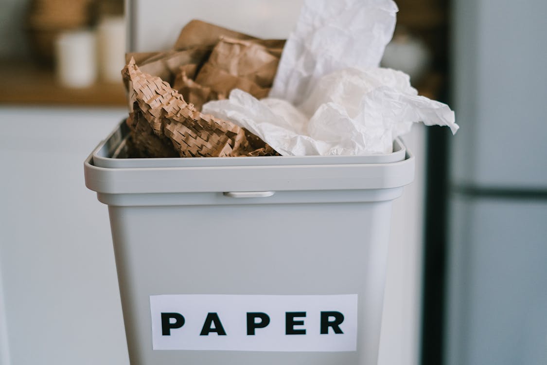 Free Closeup of plastic container full of paper placed on blurred background of kitchen in daytime Stock Photo