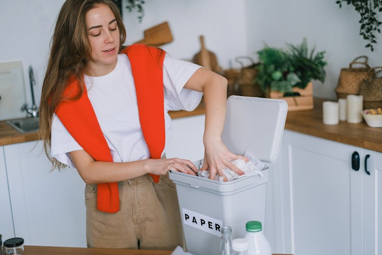 Happy Woman Sorting Trash In Bin