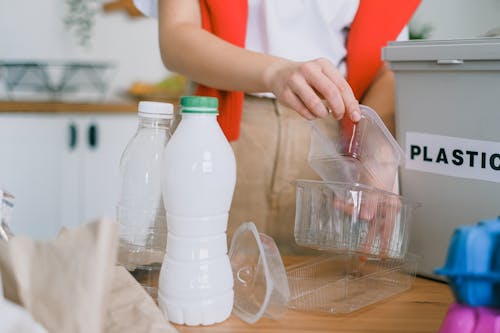 Woman sorting out plastic wastes at home