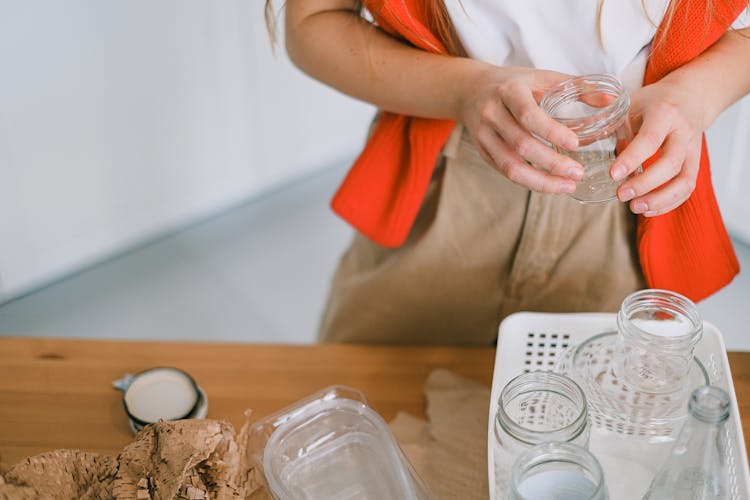 Woman Standing With Glass Jar In Hand