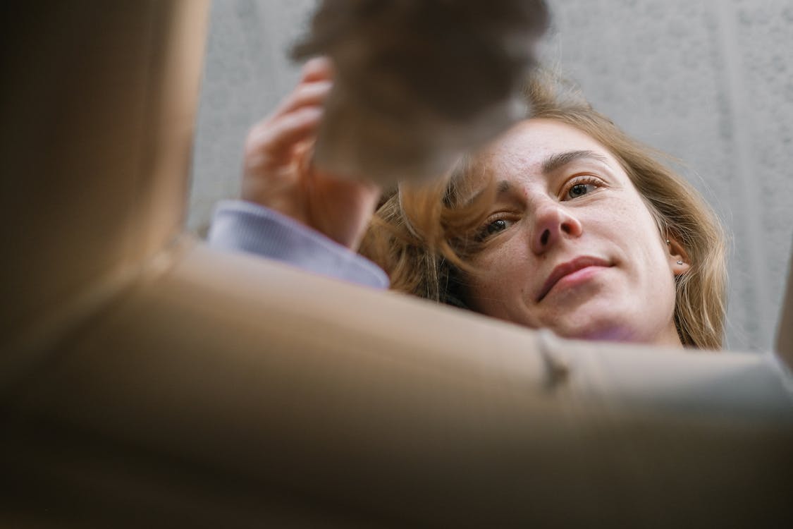 After 6 Years in Early Access, This Sandbox Gem Just Hit 1.0 and It's Massive 2 A group of friends laughing while playing a video game together on a couch, representing multiplayer fun.