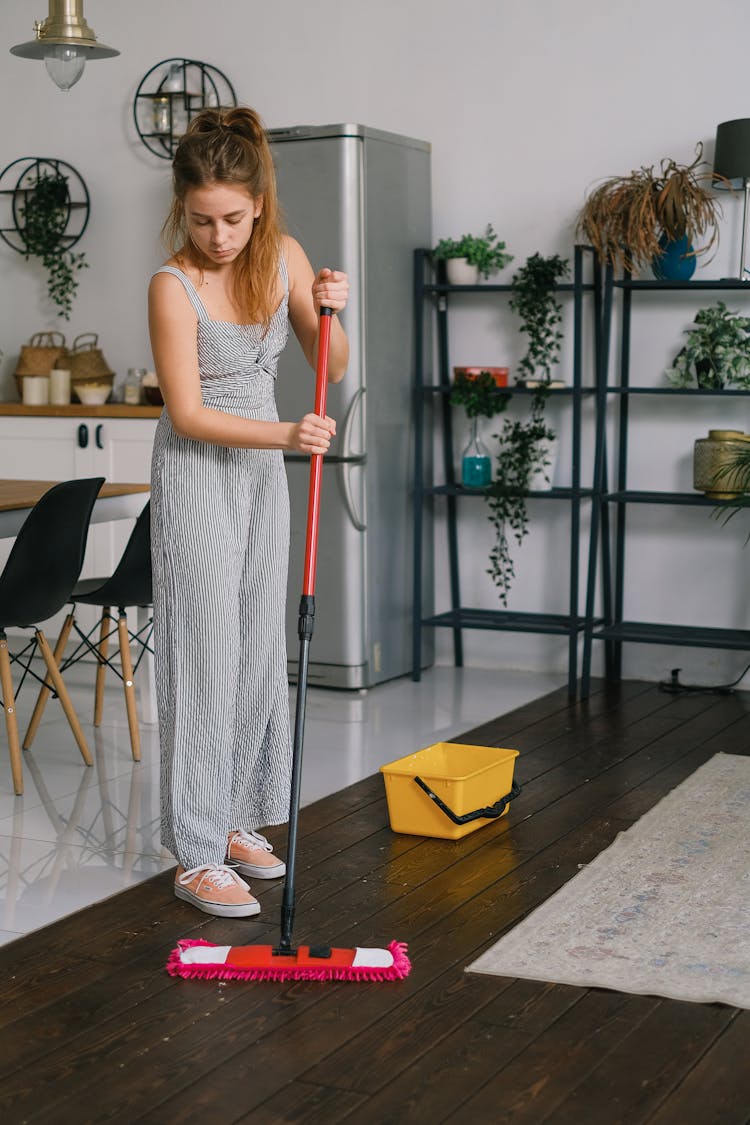 Housewife Washing Floor With Mop At Home