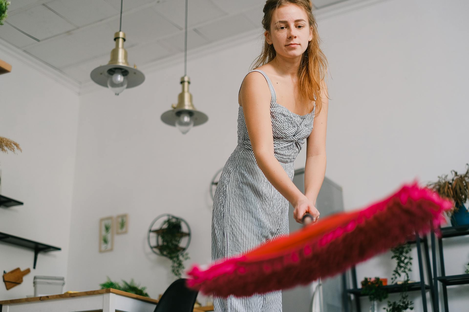 Crop housewife preparing to mop floor at home