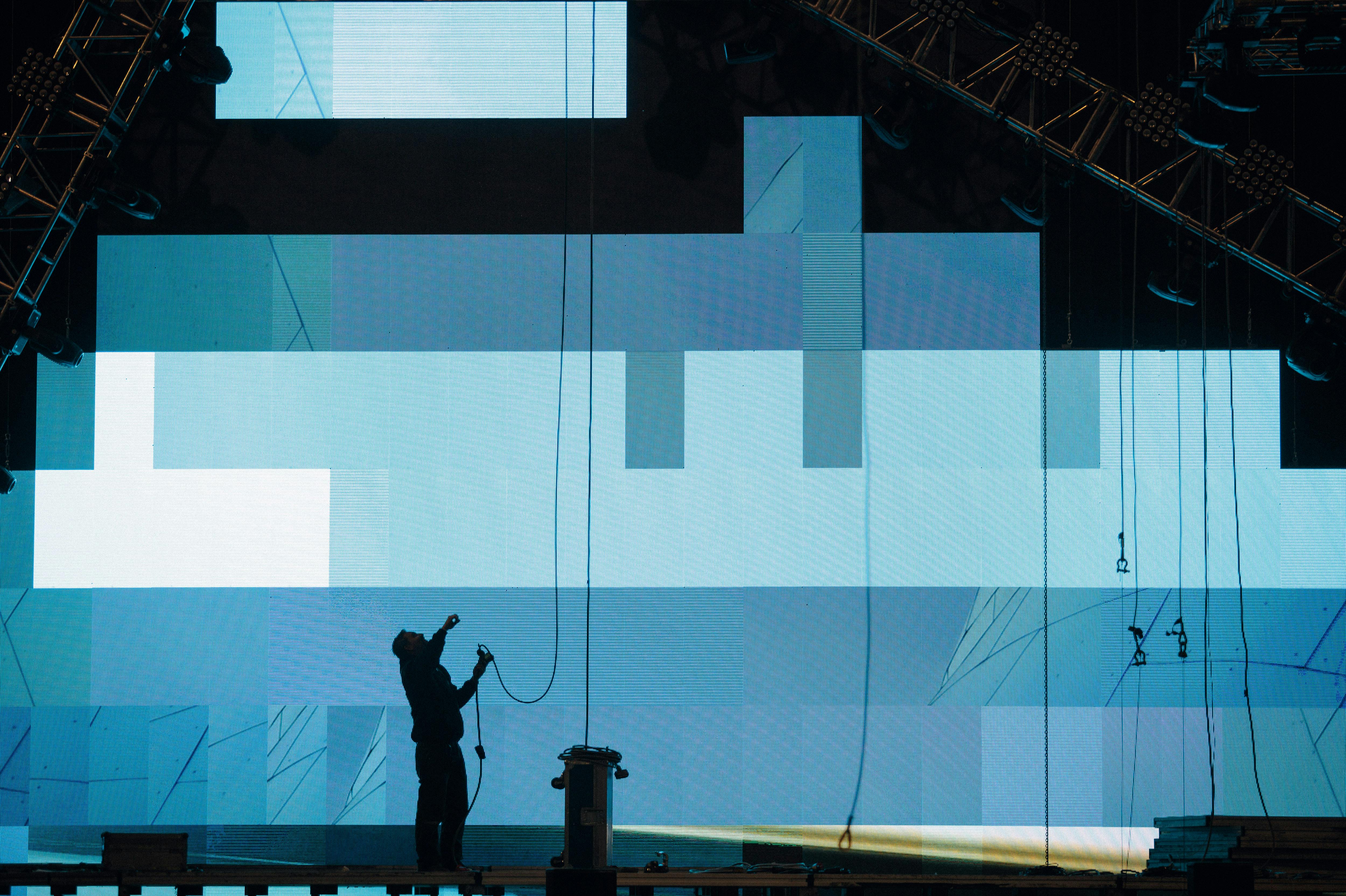 A stage technician with LED panels