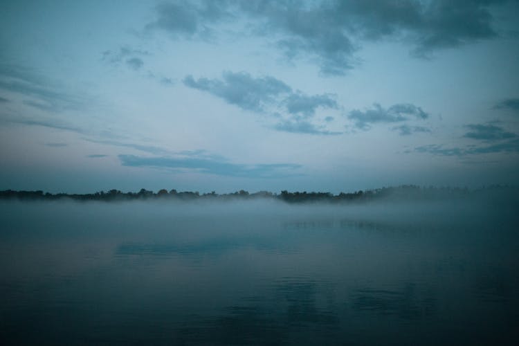 A Lake Surface Covered With Fog