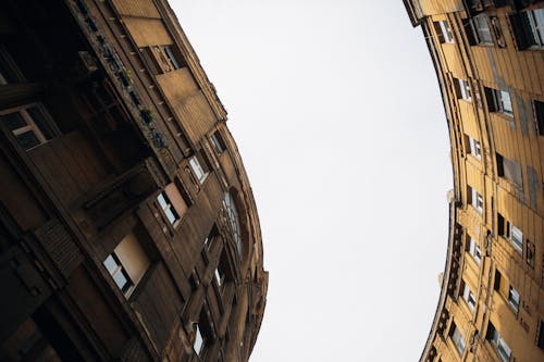 Brown Concrete Buildings Under White Sky