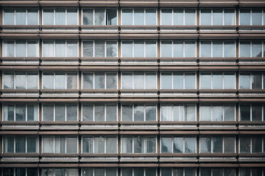 Close-up of a building facade with symmetrical window patterns, offering urban architectural design.