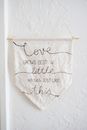 Message on fabric flag hanging on plaster wall