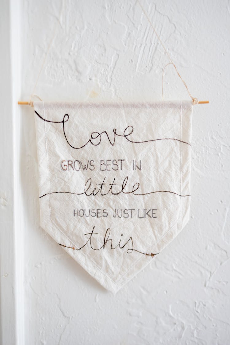 Message On Fabric Flag Hanging On Plaster Wall