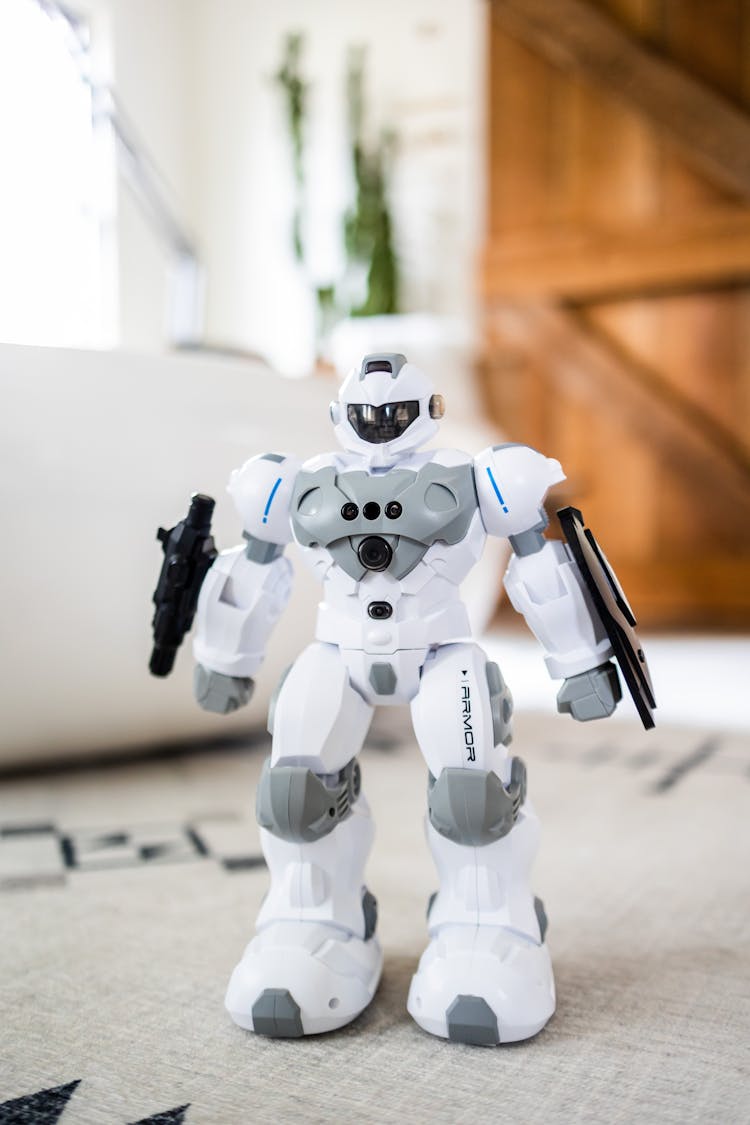 Toy Robot With Guns On Carpet At Home