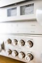 Creative design of audio stereo power amplifier with rows of knobs under volume meters with indicators