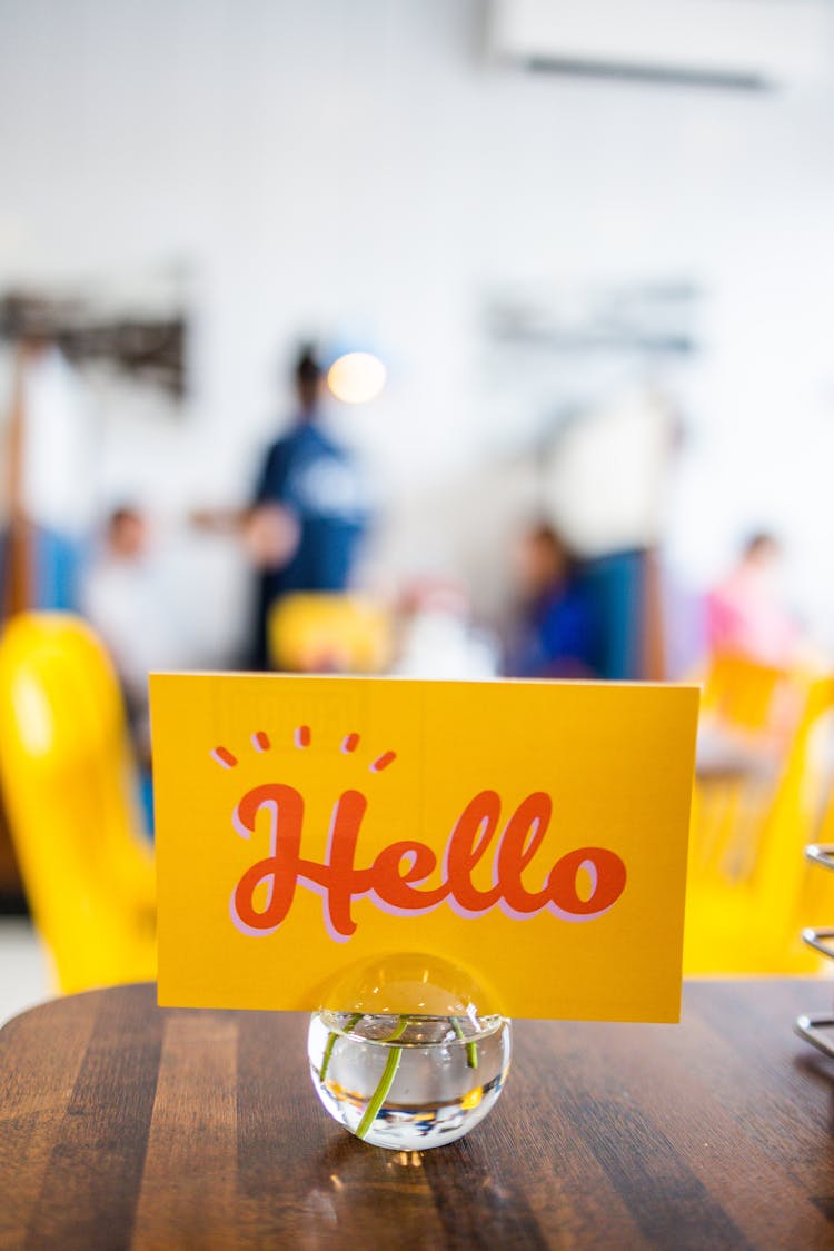 Sign With Hello Inscription On Table In Cafe