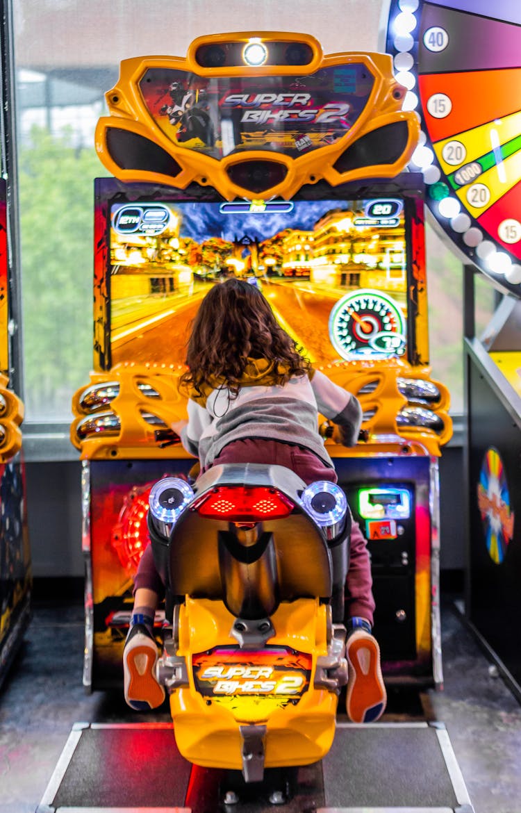 Anonymous Girl Playing Gaming Machine In Club