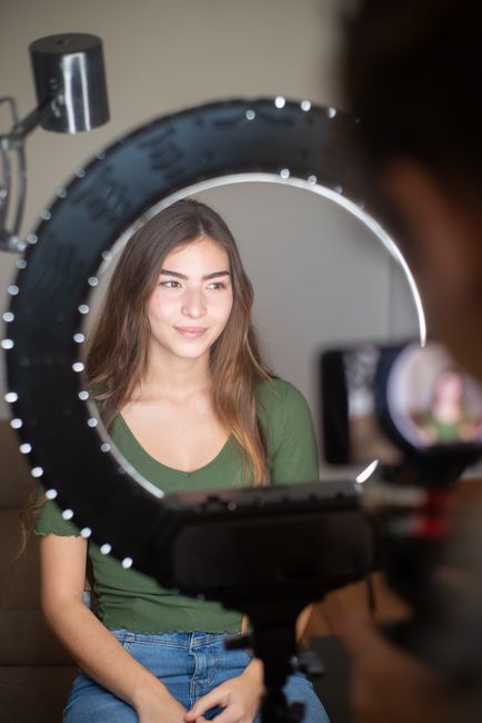 Video creator recording with a ring light — photo by Kampus Production on Pexels