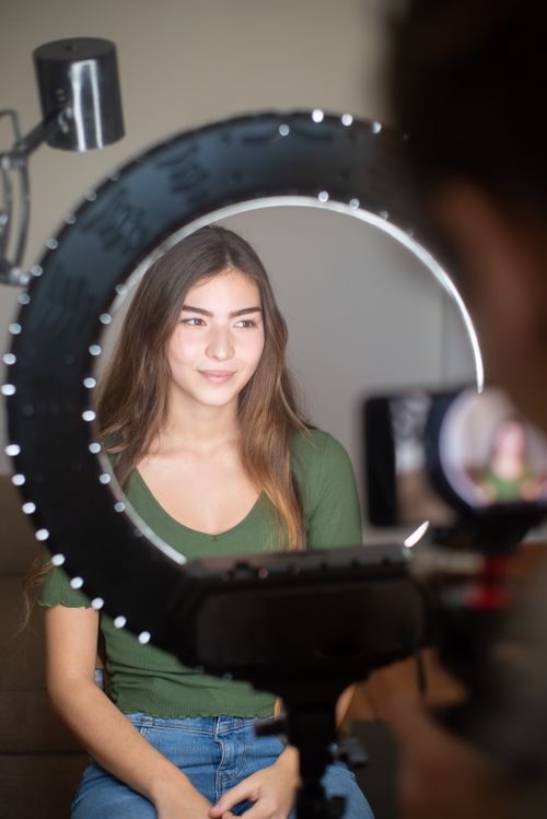 Creator streaming at home behind a ring light — photo by Kampus Production on Pexels