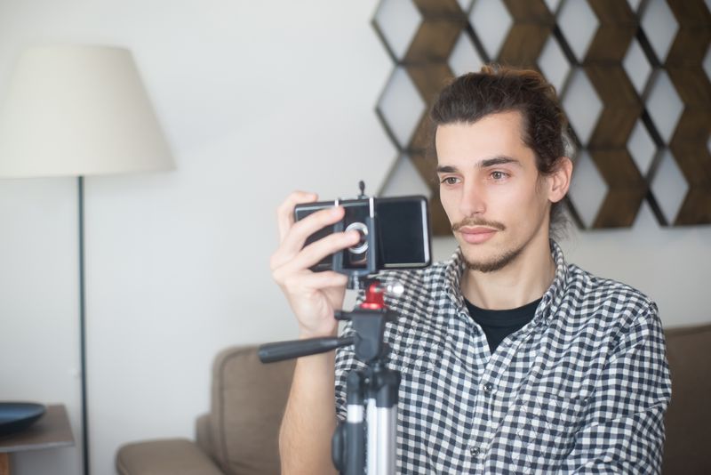 Influencer filming content with a smartphone on a tripod