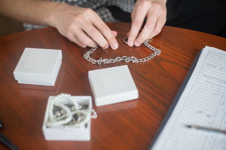 A Person Holding Chain Necklace