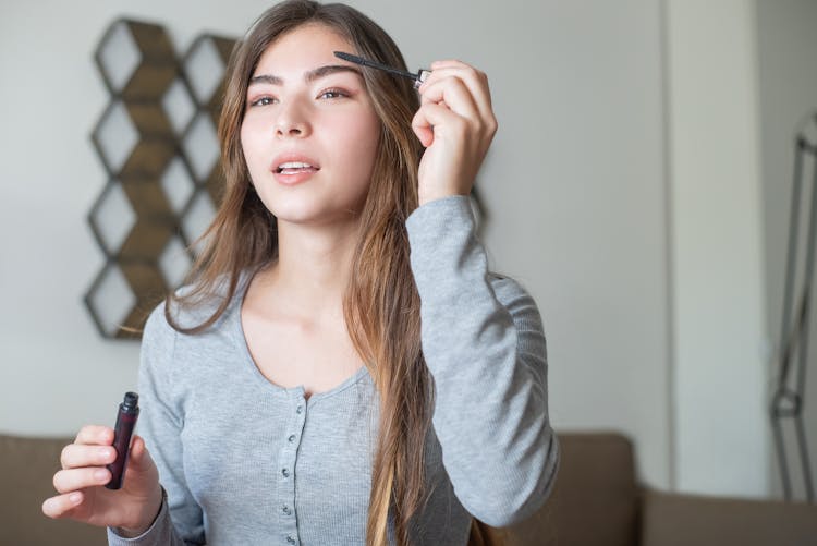 A Woman Applying Eyebrow Makeup