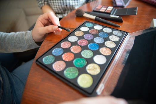 Vibrant glitter eyeshadows with makeup brushes on wooden table. Perfect for beauty and fashion themes.