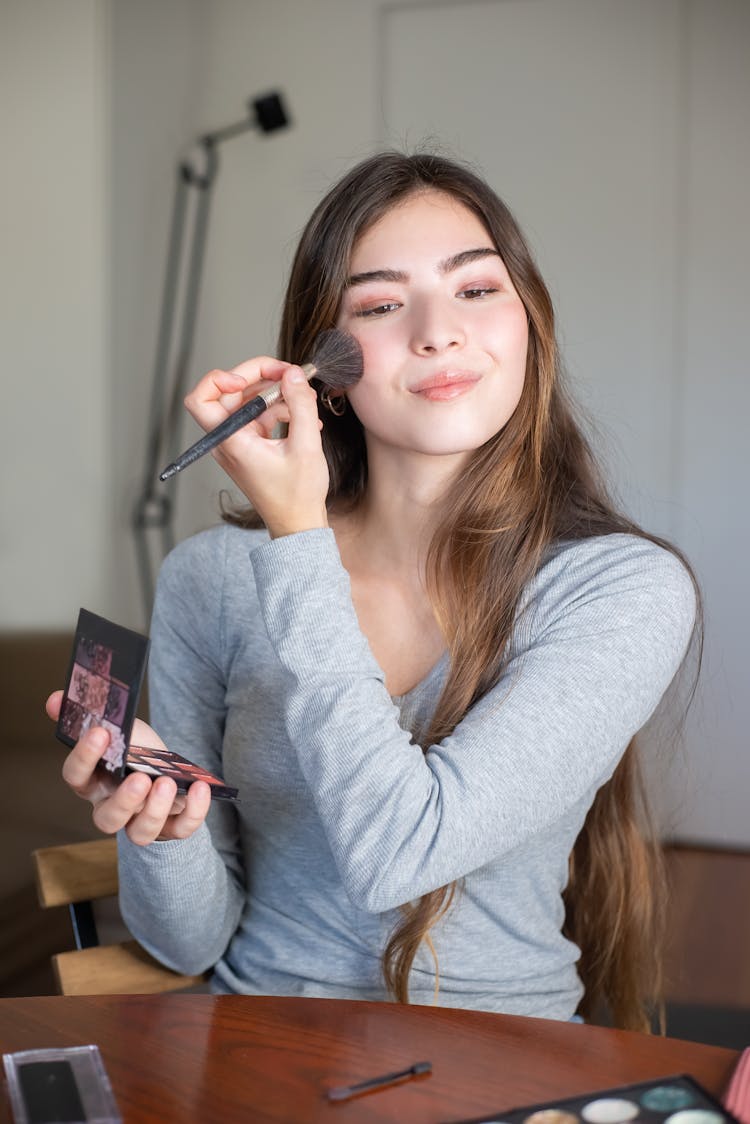 Woman Applying Makeup On Her Face