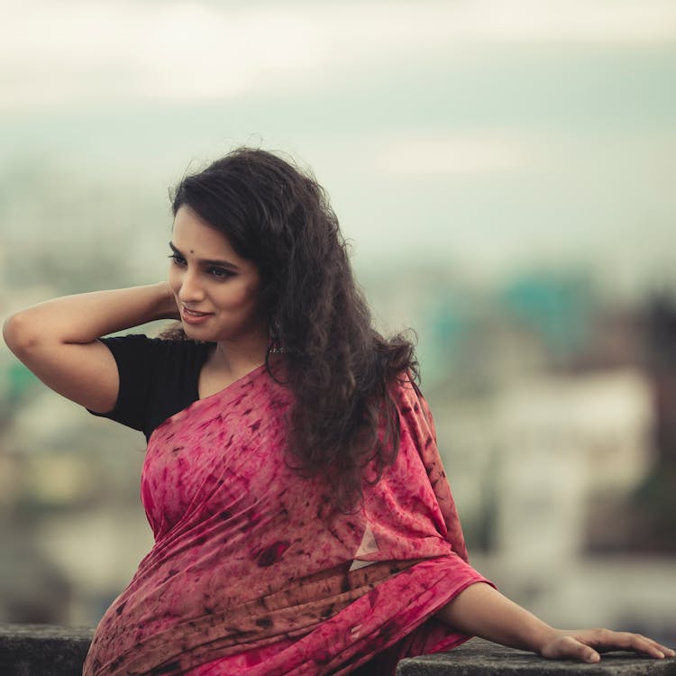 A Woman In A Red Saree Posing