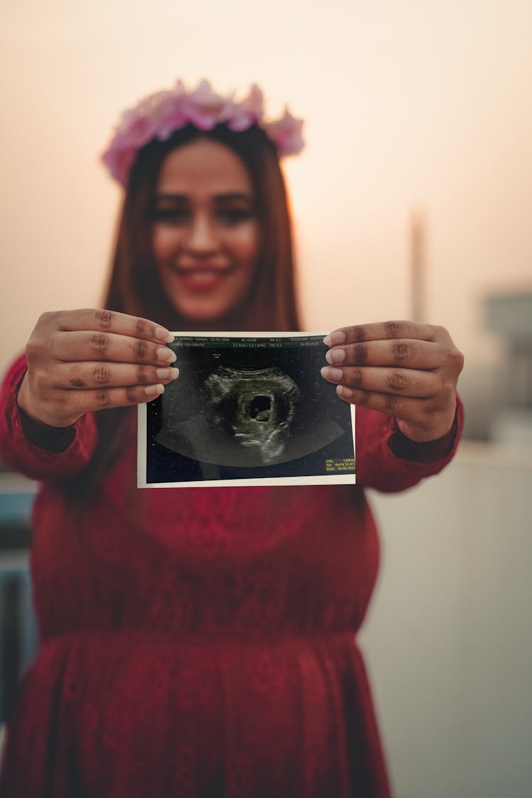 A Woman Holding A Sonogram