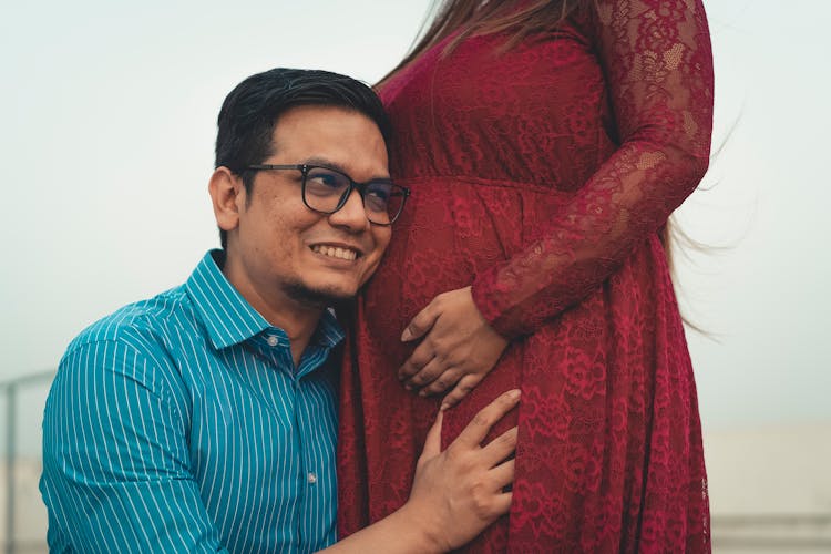 A Man Hearing Belly Of A Pregnant Woman
