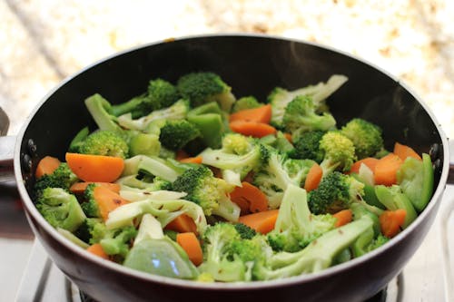 Free Green and Orange Vegetable on Black Ceramic Bowl Stock Photo