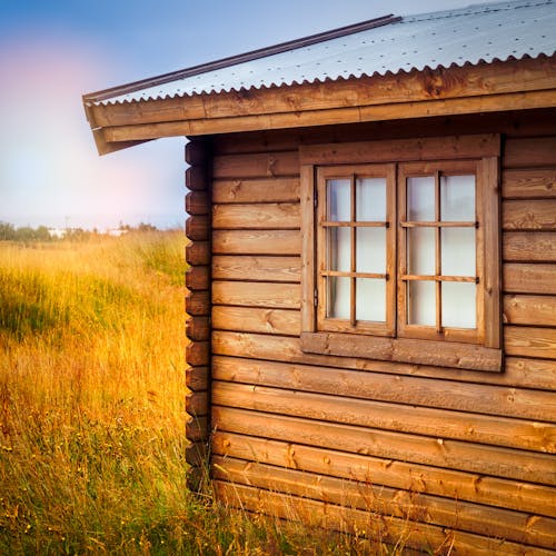 Free Brown Wooden Cottage at the Field during Day Stock Photo