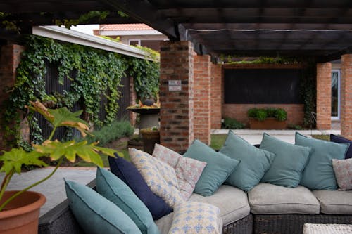 A Blue and Gray Throw Pillows on Gray Couch