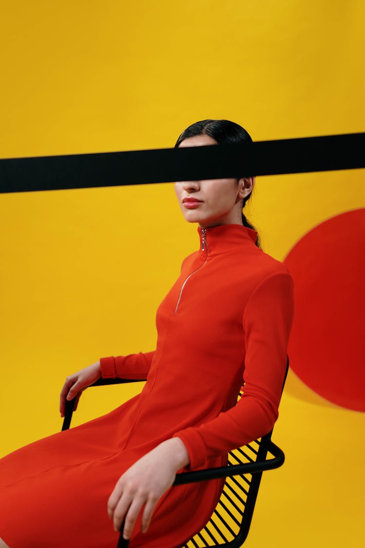 Woman In Red Long Sleeve Dress Sitting On A Chair