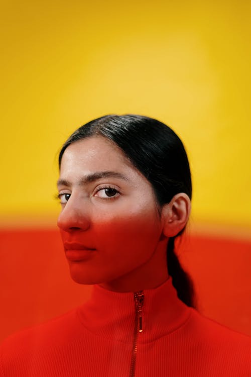 Portrait of a Young Woman in Split Yellow and Red Lighting 