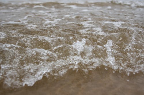 Small Water Waves on Brown Sand