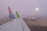 View on an Airplane Wing from the Inside of the Plane at an Airport