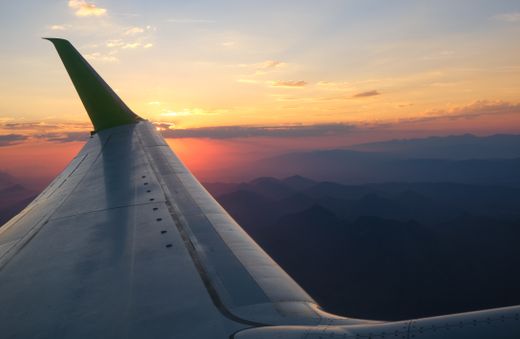 Wing view over mountain ridges at sunset — photo by Magda Ehlers on Pexels