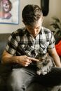 Photo of Cat on Man's Lap