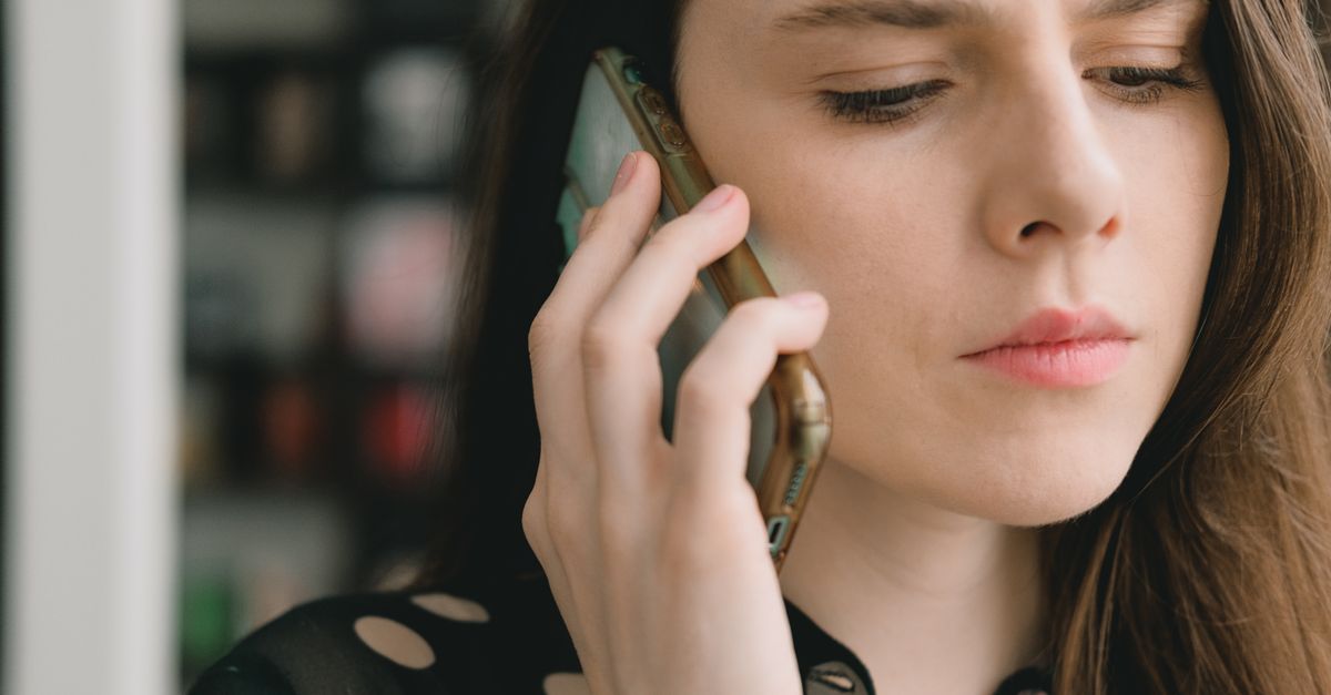 person cancelling subscription on phone with thoughtful expression