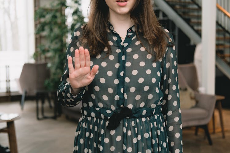 Crop Feminine Woman Showing Stop Gesture In Modern Apartment