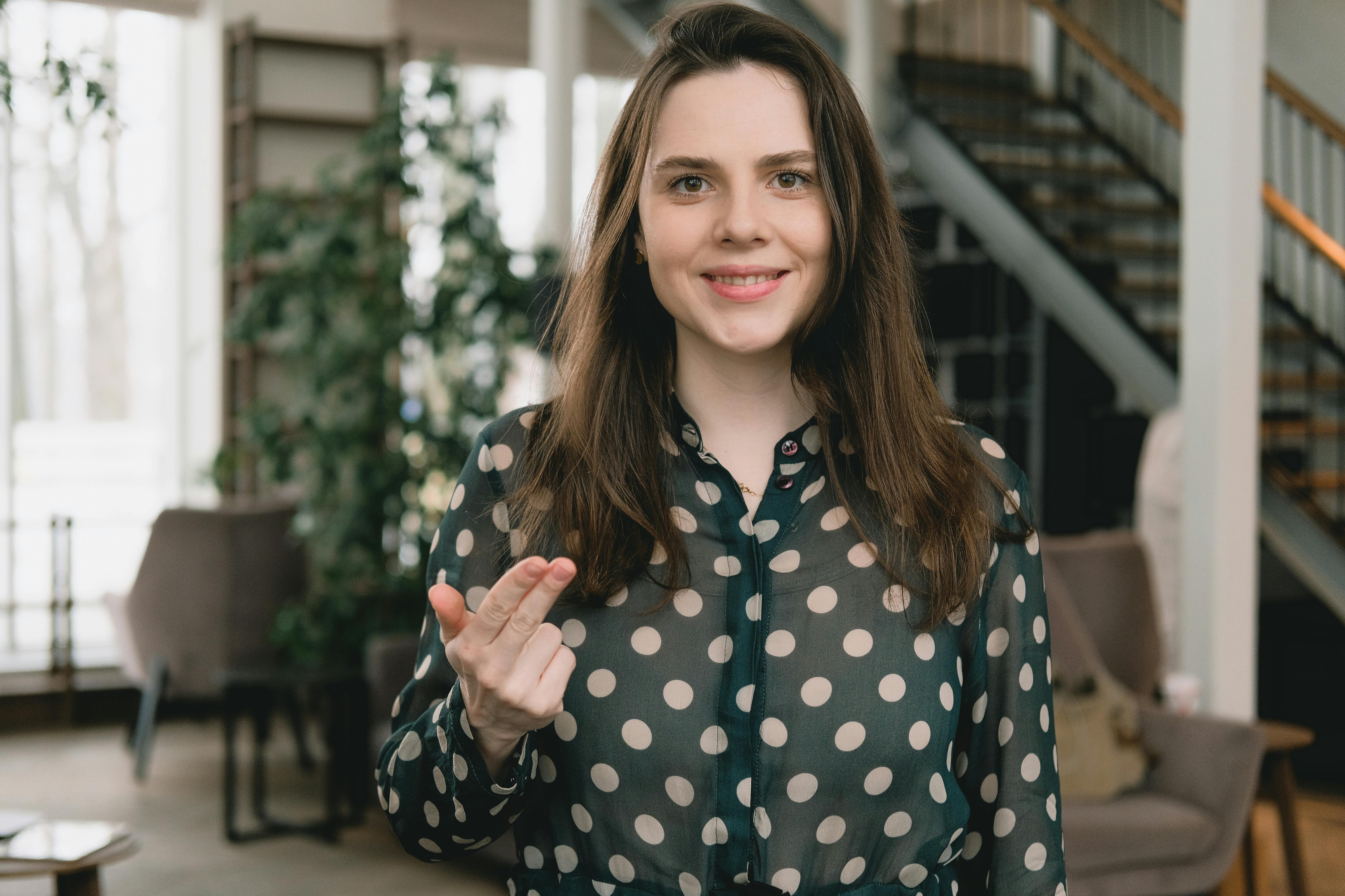 happy young woman smiling at camera while recording video