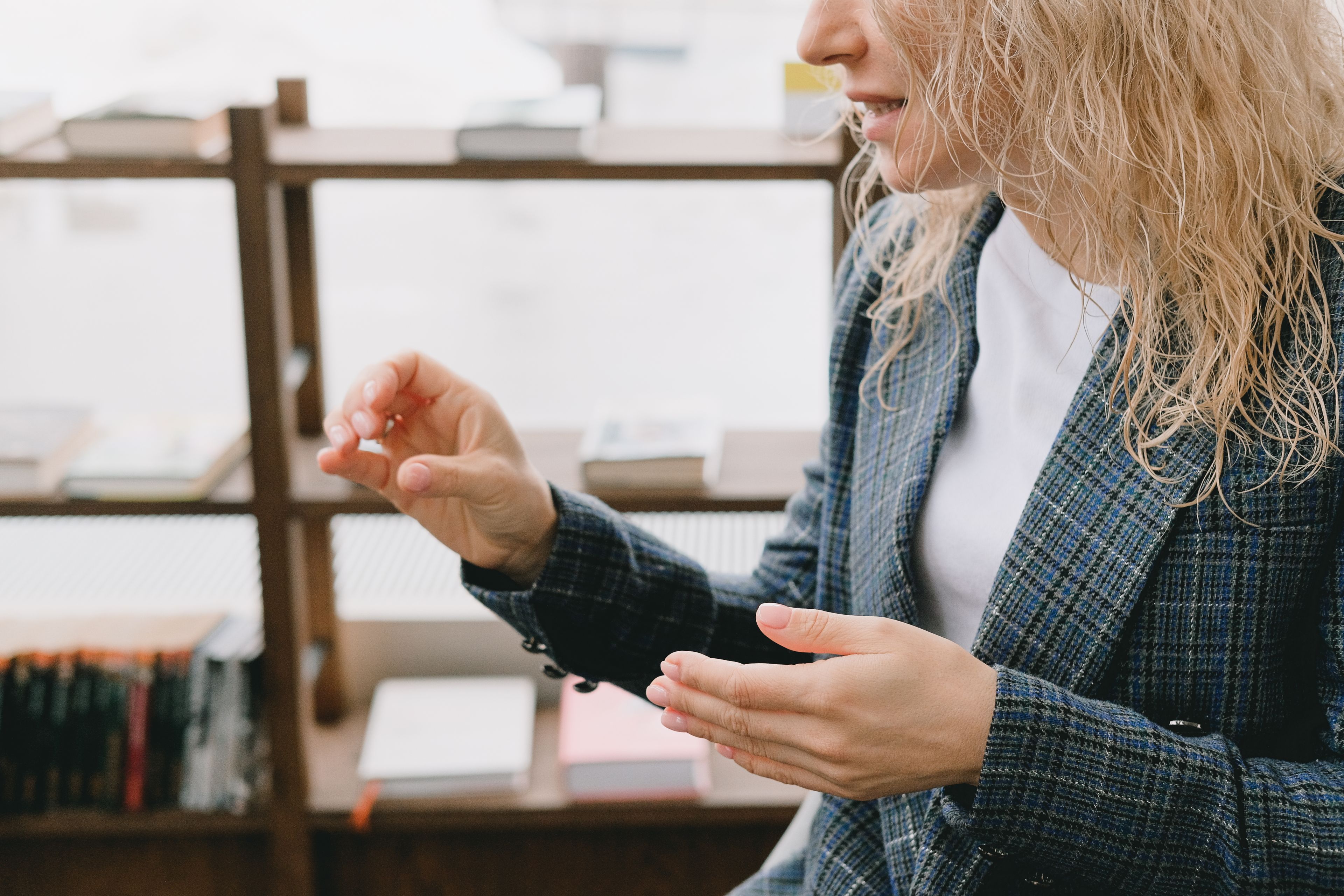Candidate using hand gestures to explain a work example during a job interview in an office