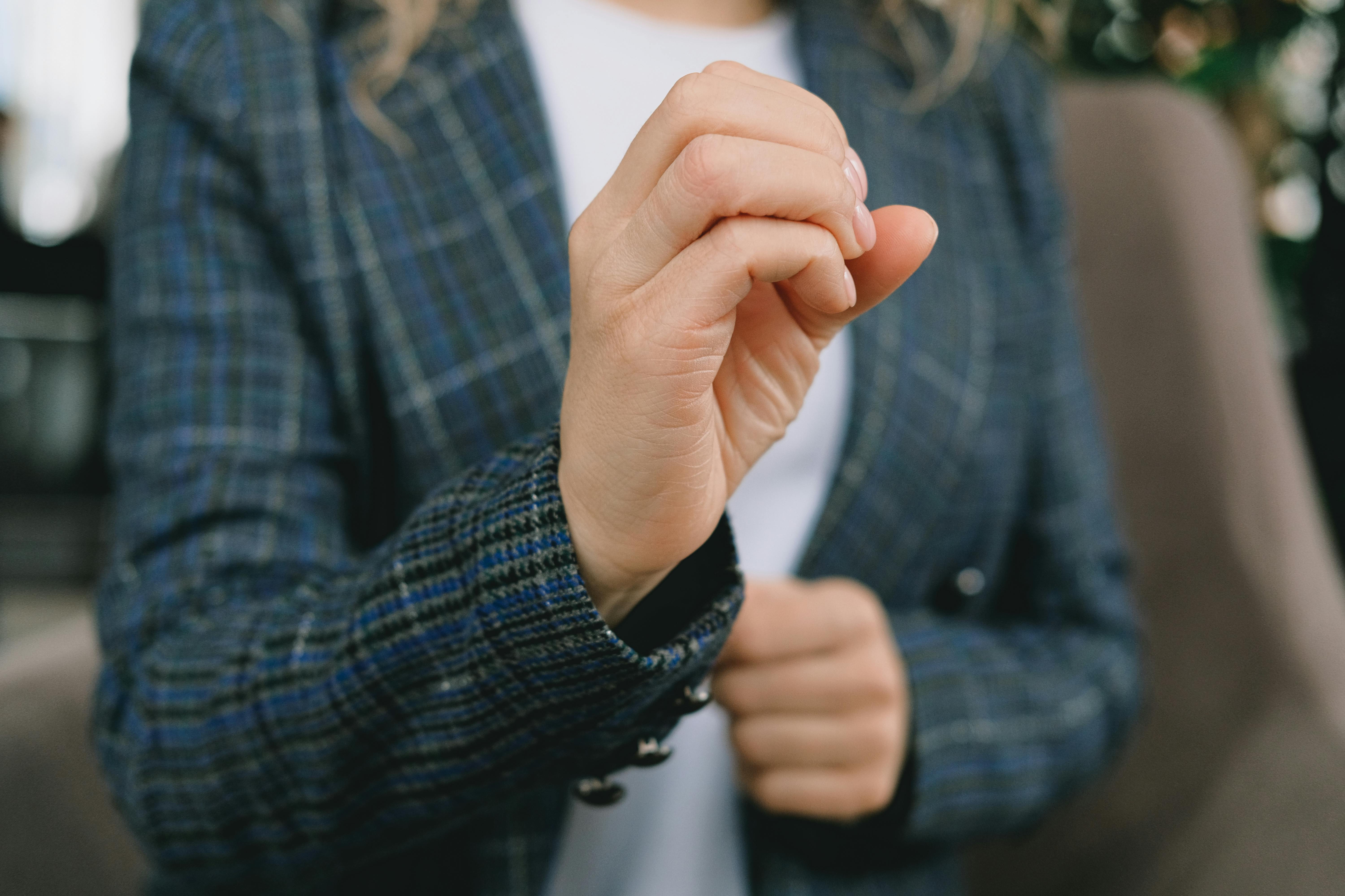 anonymous lady showing o letter using sign language