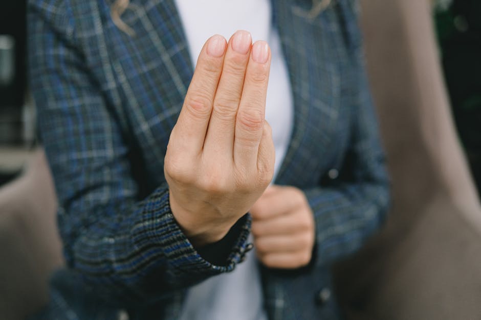 Crop female showing three fingers sign to camera