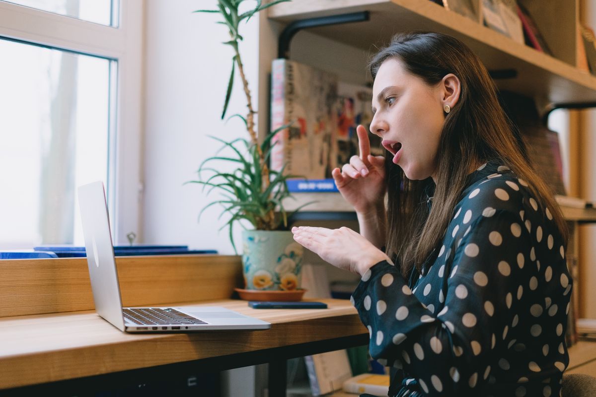 a person looking confused at a computer screen with chat bubbles