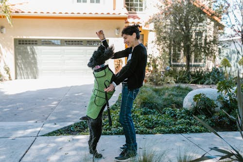 Photograph of a Woman Playing with Her Dog