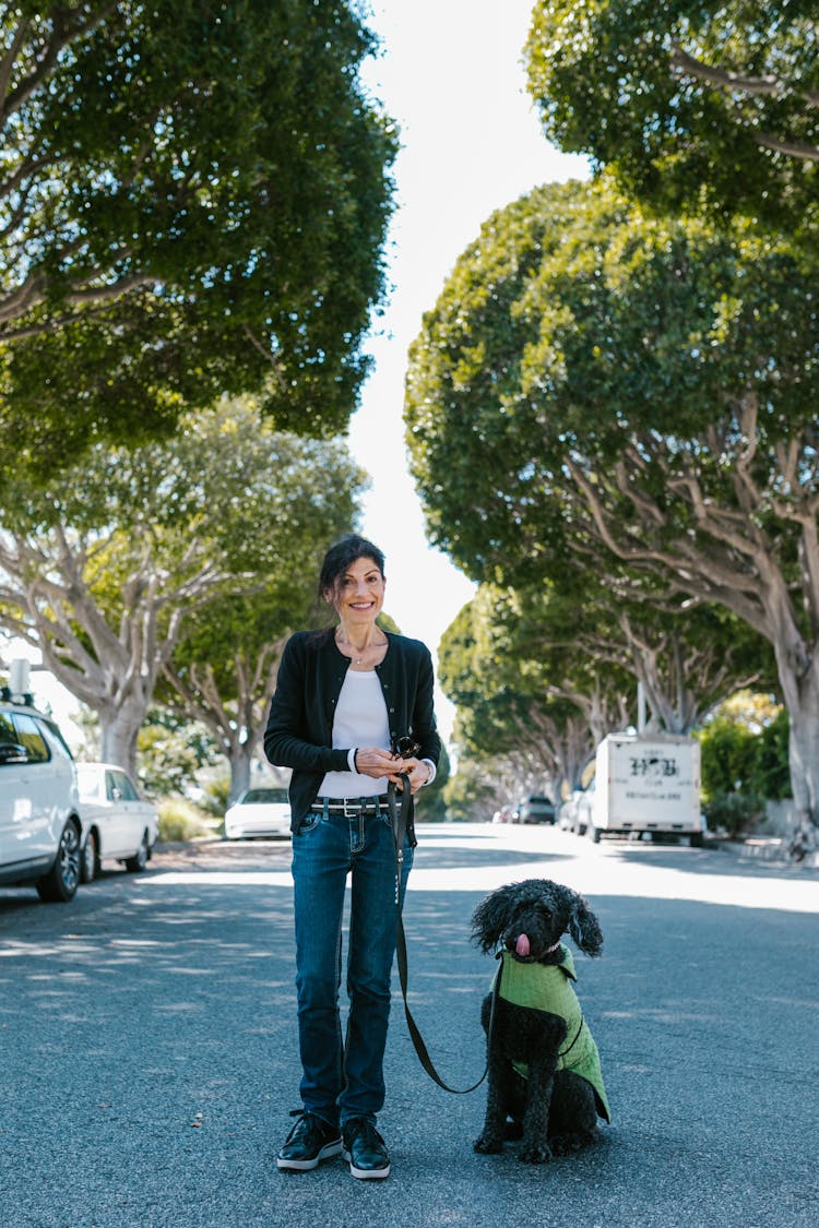 A Woman And Dog On The Road 