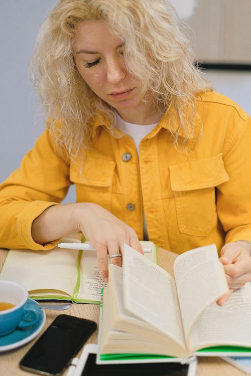 Free Student making notes while studying Stock Photo